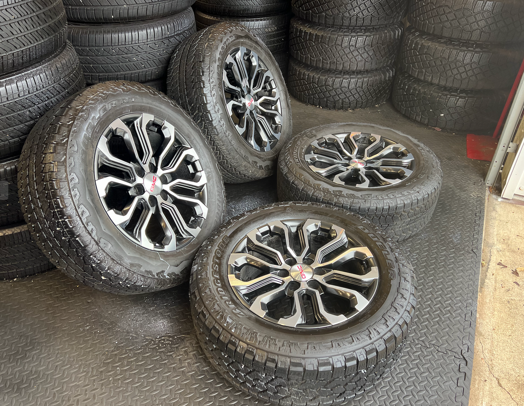 OEM 20” Charcoal Machined Wheels wrapped in Bridgestone Dueler A/T tires.