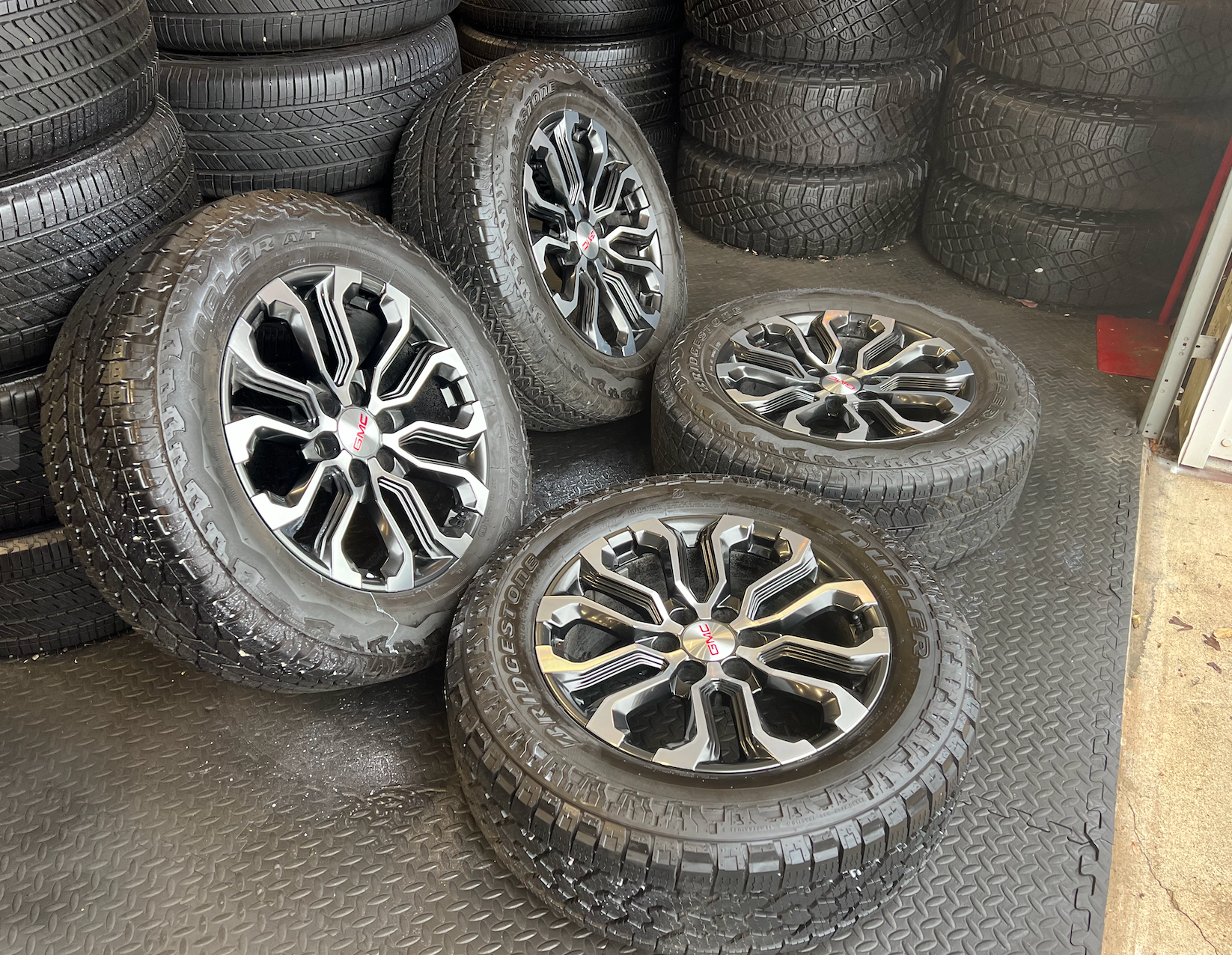 OEM 20” Charcoal Machined Wheels wrapped in Bridgestone Dueler A/T tires.