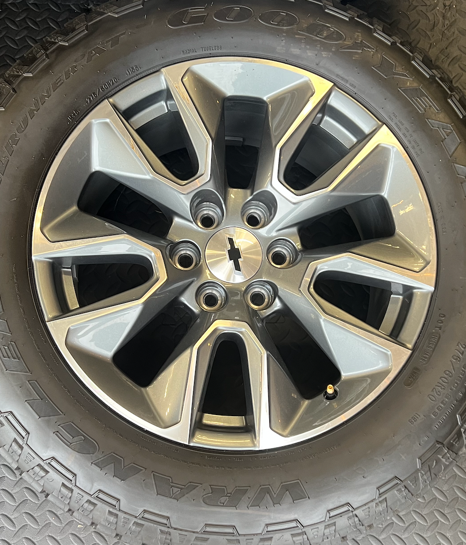 OEM 20”  Gunmetal & Machined Wheels wrapped in Goodyear Wrangler TrailRunner A/T tires.