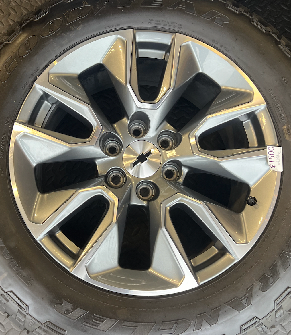 OEM 20”  Gunmetal & Machined Wheels wrapped in Goodyear Wrangler TrailRunner A/T tires.