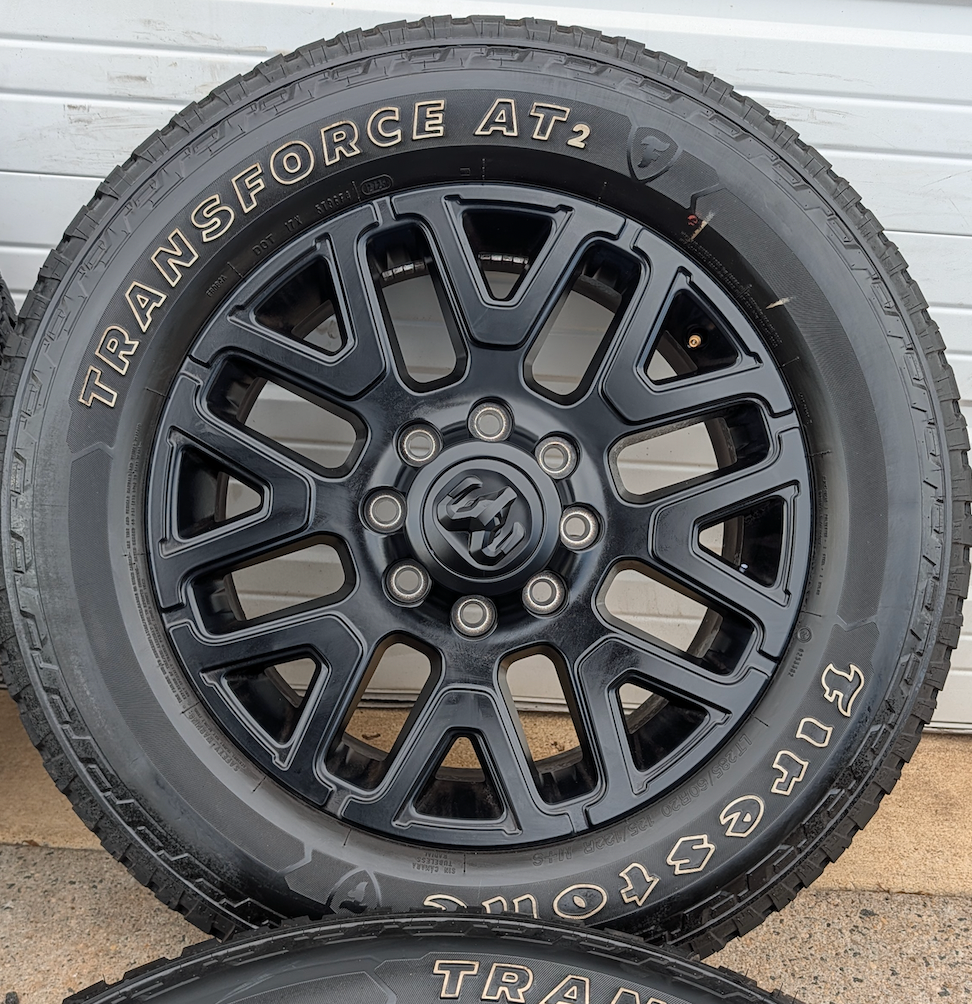 Matte Black Ram 2500 / 3500 OEM 20” Wrapped in Firestone Transforce AT2 LT285/60R20