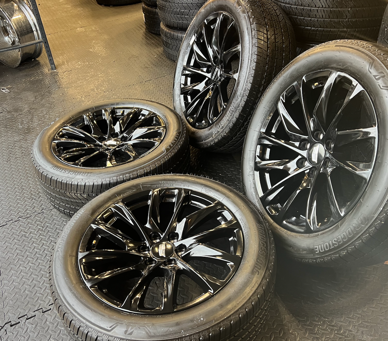 OEM 22” Gloss Black Wheels wrapped in Bridgestone tires.