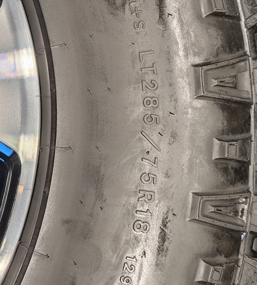 OEM 18” Gloss Black Machined Ford F-250 / F-350 Tremor Wheels wrapped in LT285/75R18 Goodyear Wrangler DuraTrac tires.