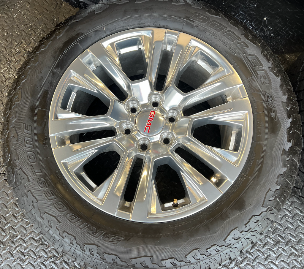 OEM Rebuilt 20” Polished Wheels wrapped in Bridgestone Dueler tires.