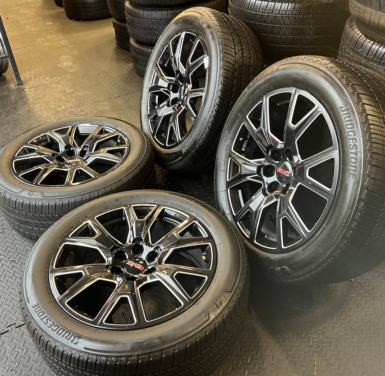 OEM 22” Gloss Black Machined Wheels wrapped in Bridgestone tires.