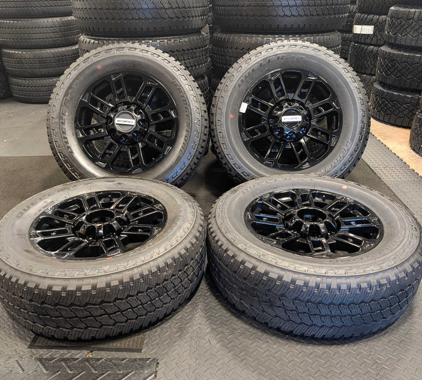 OEM 20” Gloss Black Ford F-250 / F-350 Wheels wrapped in Bridgestone Dueler A/T tires.