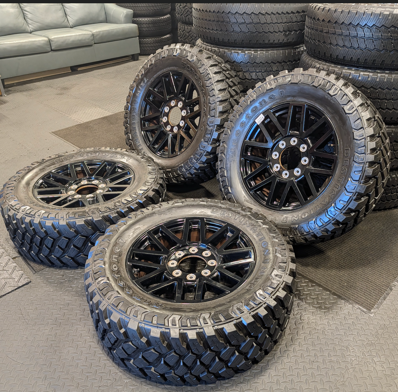 OEM 20” Gloss Black Ford F-250 / F-350 Super Duty Wheels wrapped in Firestone Destination M/T2 tires.