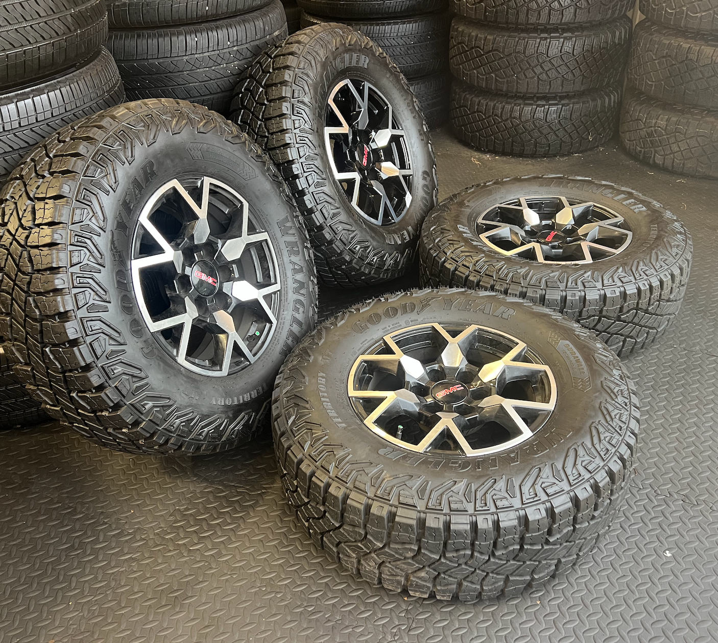 OEM 17”  Wheels with Black & Machined Finish wrapped in Goodyear Wrangler Territory M/T tires.