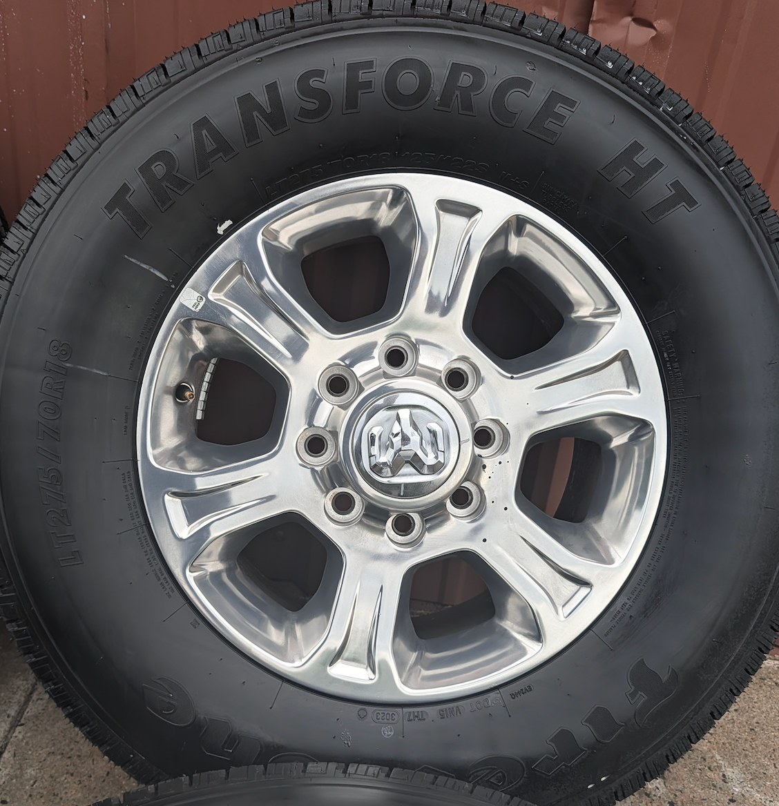 Polished Aluminum Ram 2500 / 3500 OEM 18” Wrapped in Firestone Transforce HT LT275/70R18
