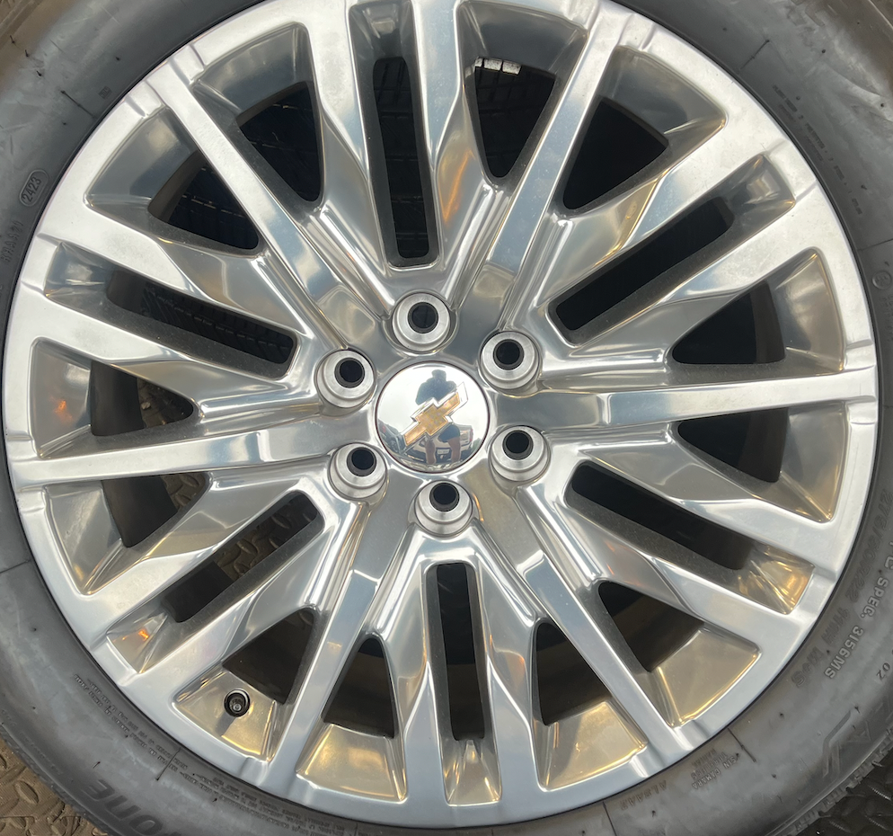 OEM 22” Polished 6-Split-Spoke Chevrolet Wheels wrapped in Bridgestone tires.