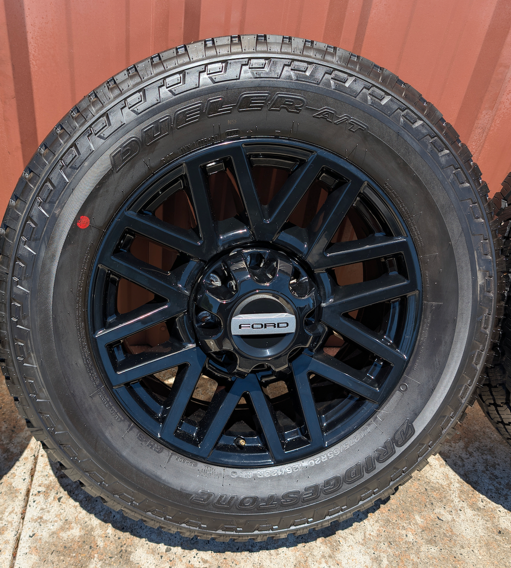 OEM 20” Chevrolet Silverado RST Gunmetal & Machined Wheels wrapped in Goodyear Wrangler TrailRunner A/T tires.