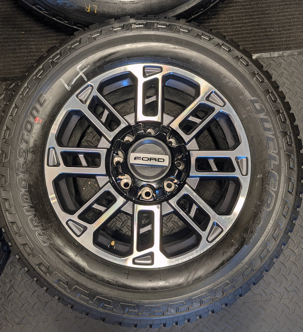 OEM 20” Ford Limited / Platinum Wheels wrapped in Bridgestone Dueler tires.