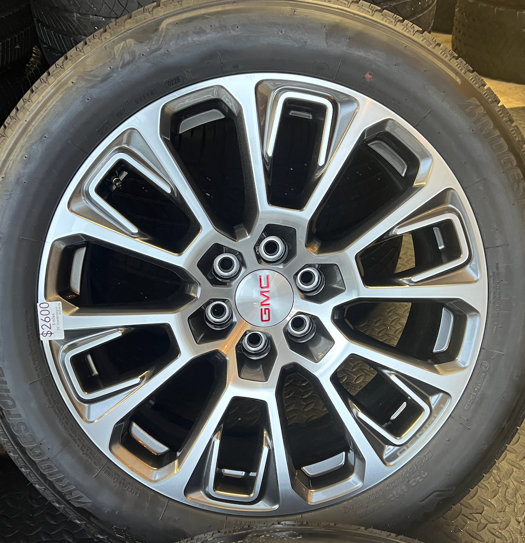 OEM 22” Machined Silver Denali Wheels wrapped in Bridgestone tires.