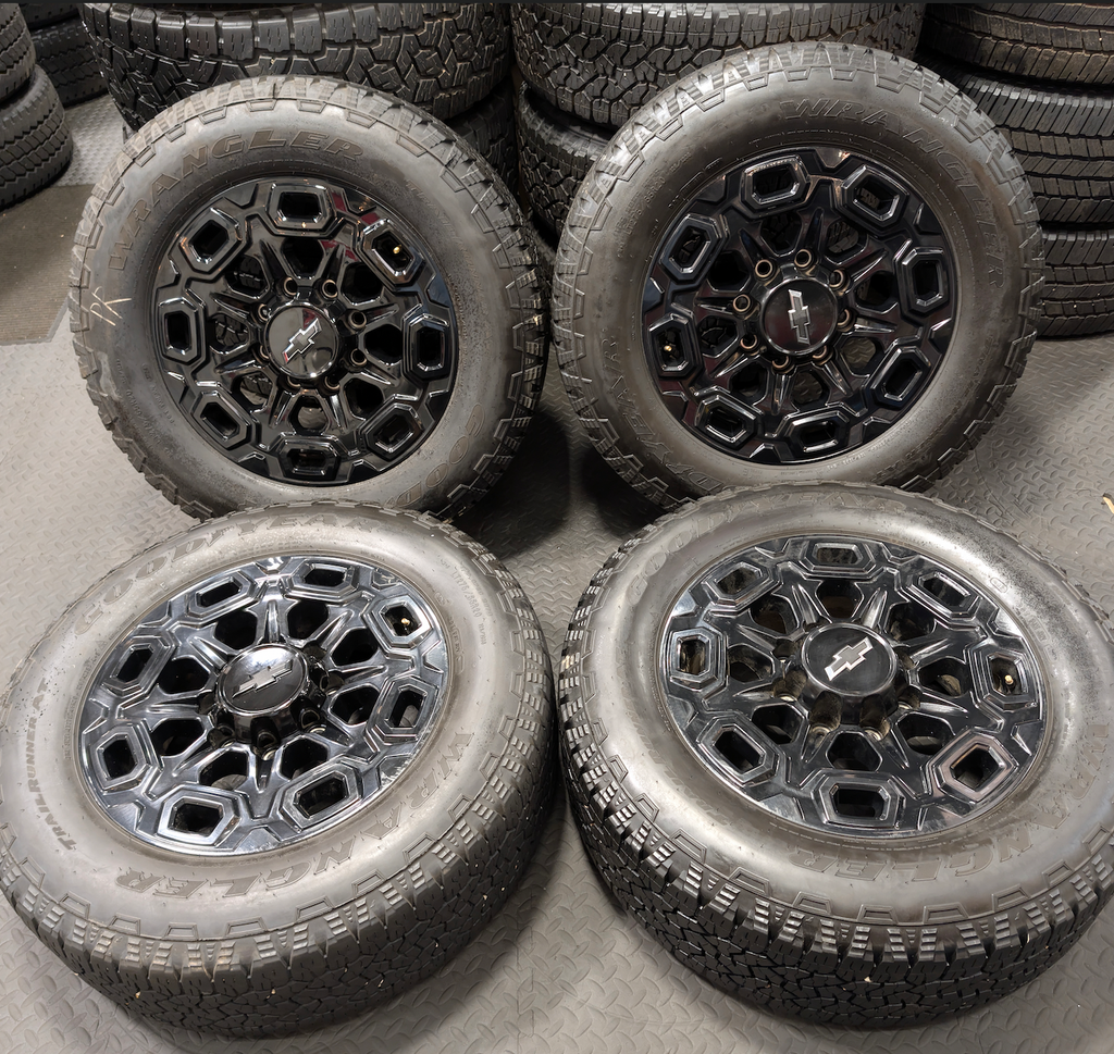 OEM 20” Gloss Black Chevrolet Silverado / GMC Sierra 2500HD & 3500HD Wheels wrapped in LT275/65R20 Goodyear Wrangler TrailRunner A/T tires.