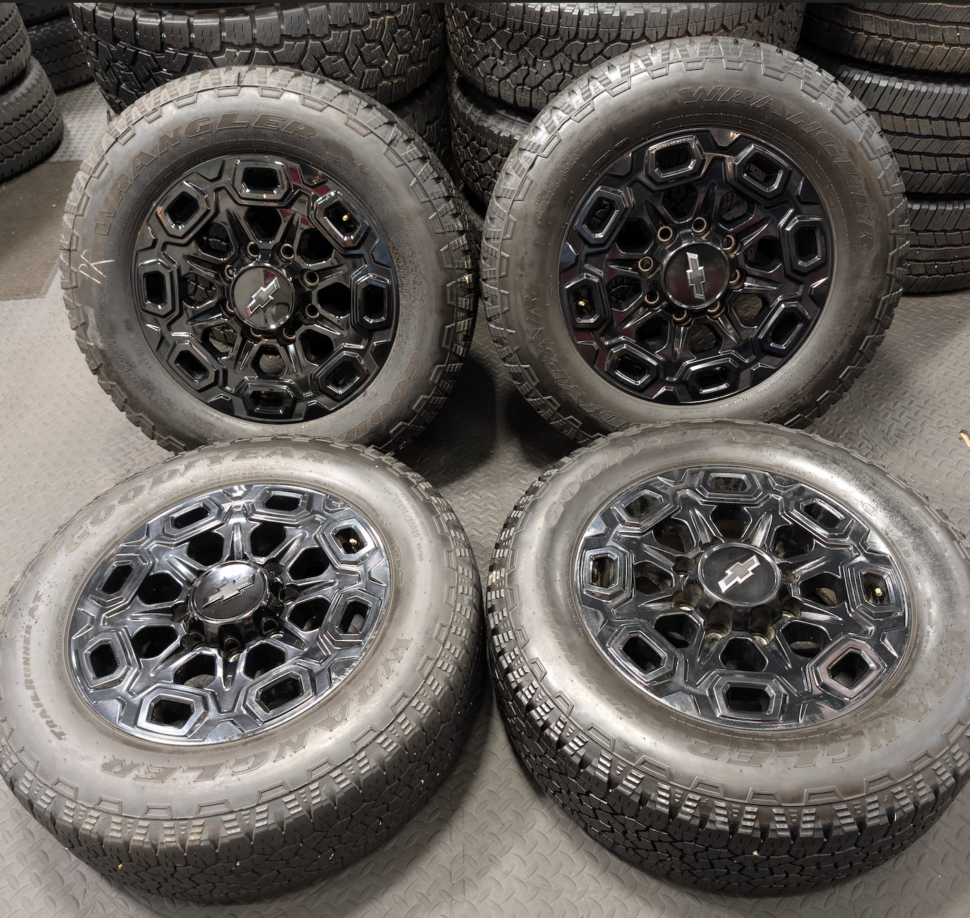OEM 20” Gloss Black Chevrolet Silverado / GMC Sierra 2500HD & 3500HD Wheels wrapped in LT275/65R20 Goodyear Wrangler TrailRunner A/T tires.