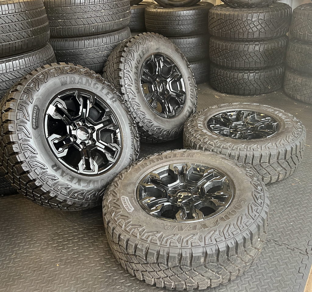 OEM 18” Gloss Black Chevrolet Silverado ZR2 Wheels wrapped in LT275/70R18 Goodyear Wrangler Territory MT tires.