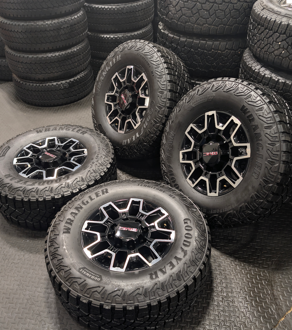 OEM 18” GMC Sierra 2500HD AT4X Black Wheels wrapped in Goodyear Wrangler Territory M/T tires.