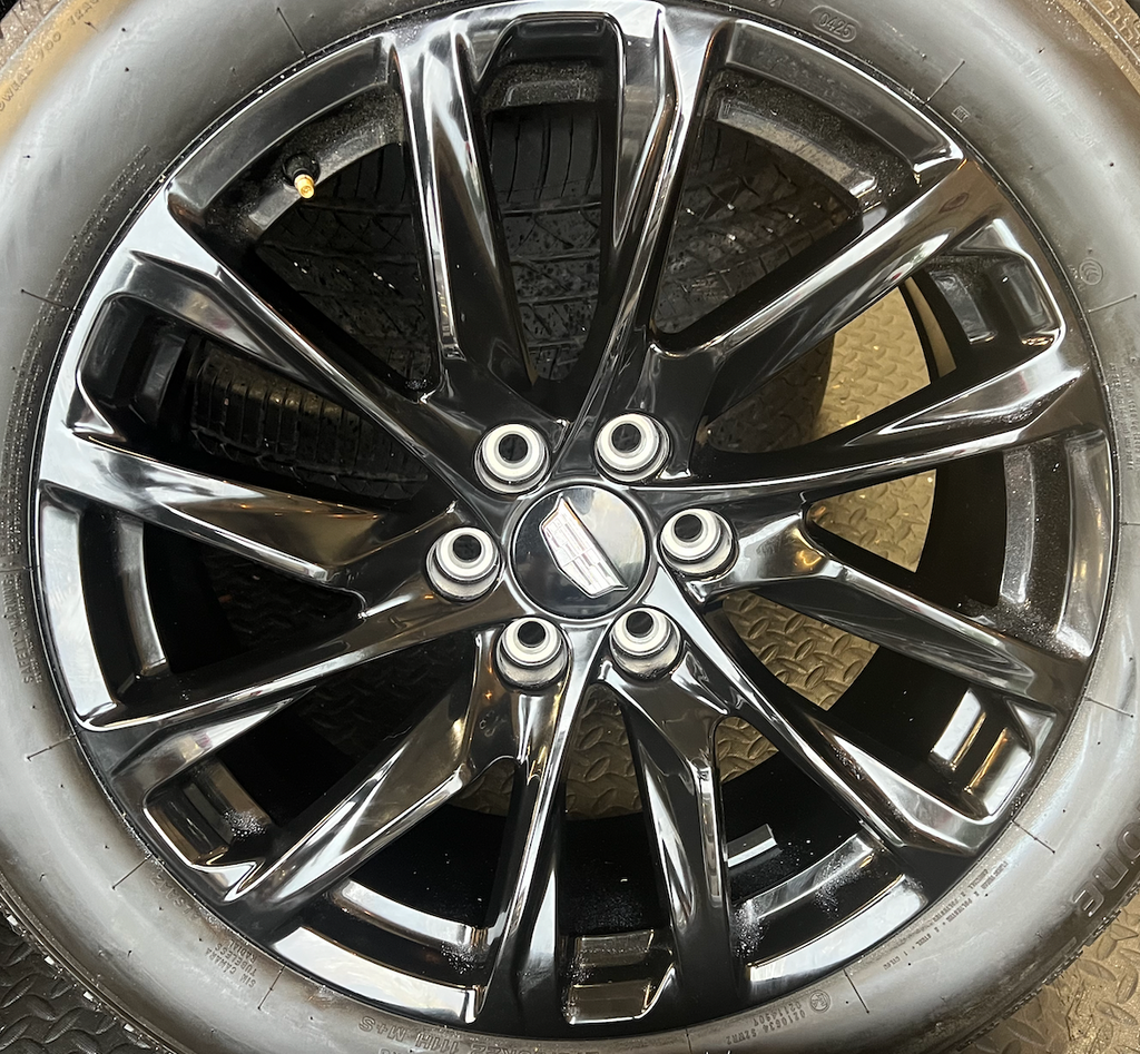 OEM 22” Gloss Black Wheels wrapped in Bridgestone tires.