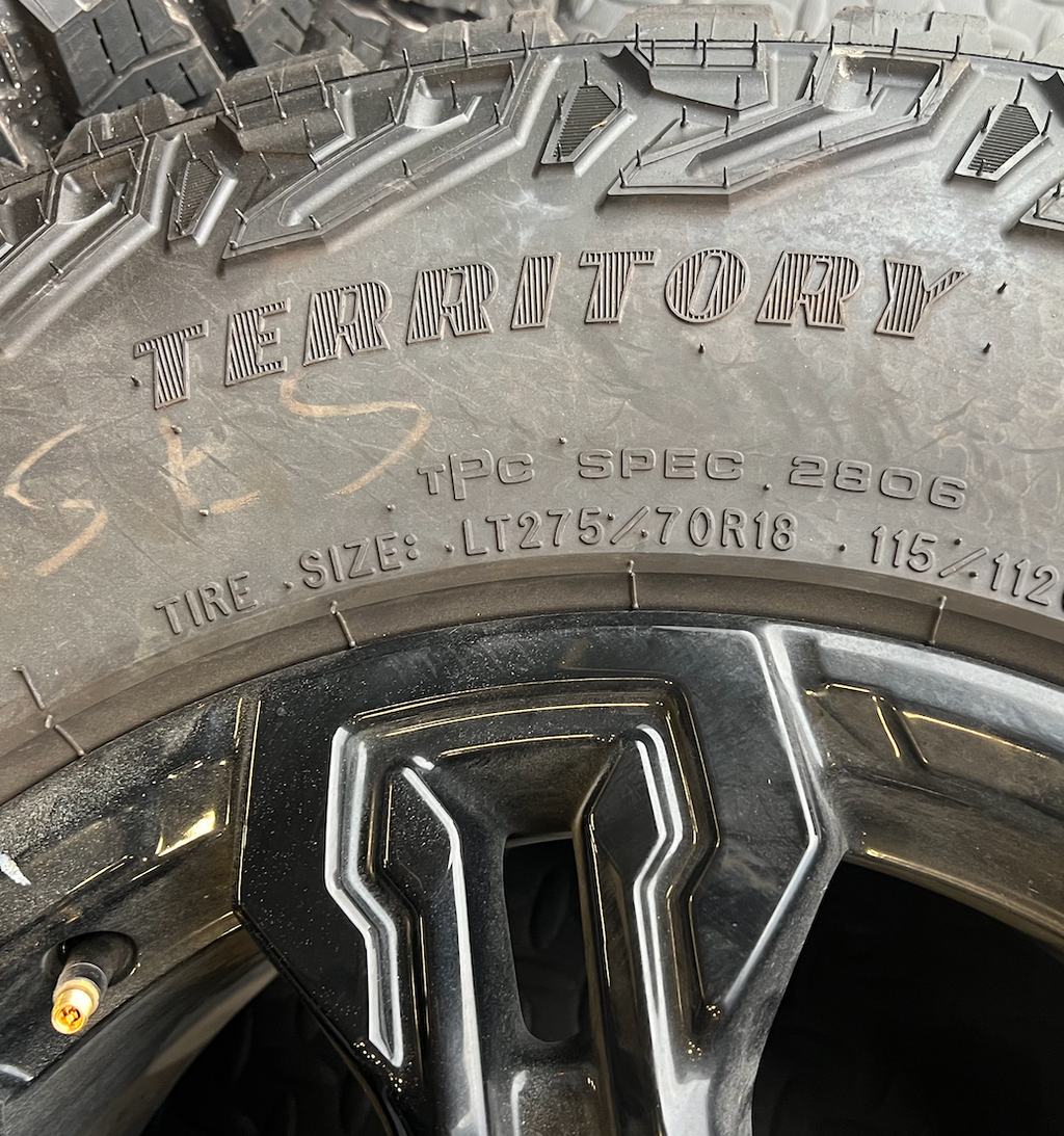 OEM 18” Gloss Black Chevrolet Silverado ZR2 Wheels wrapped in LT275/70R18 Goodyear Wrangler Territory MT tires.