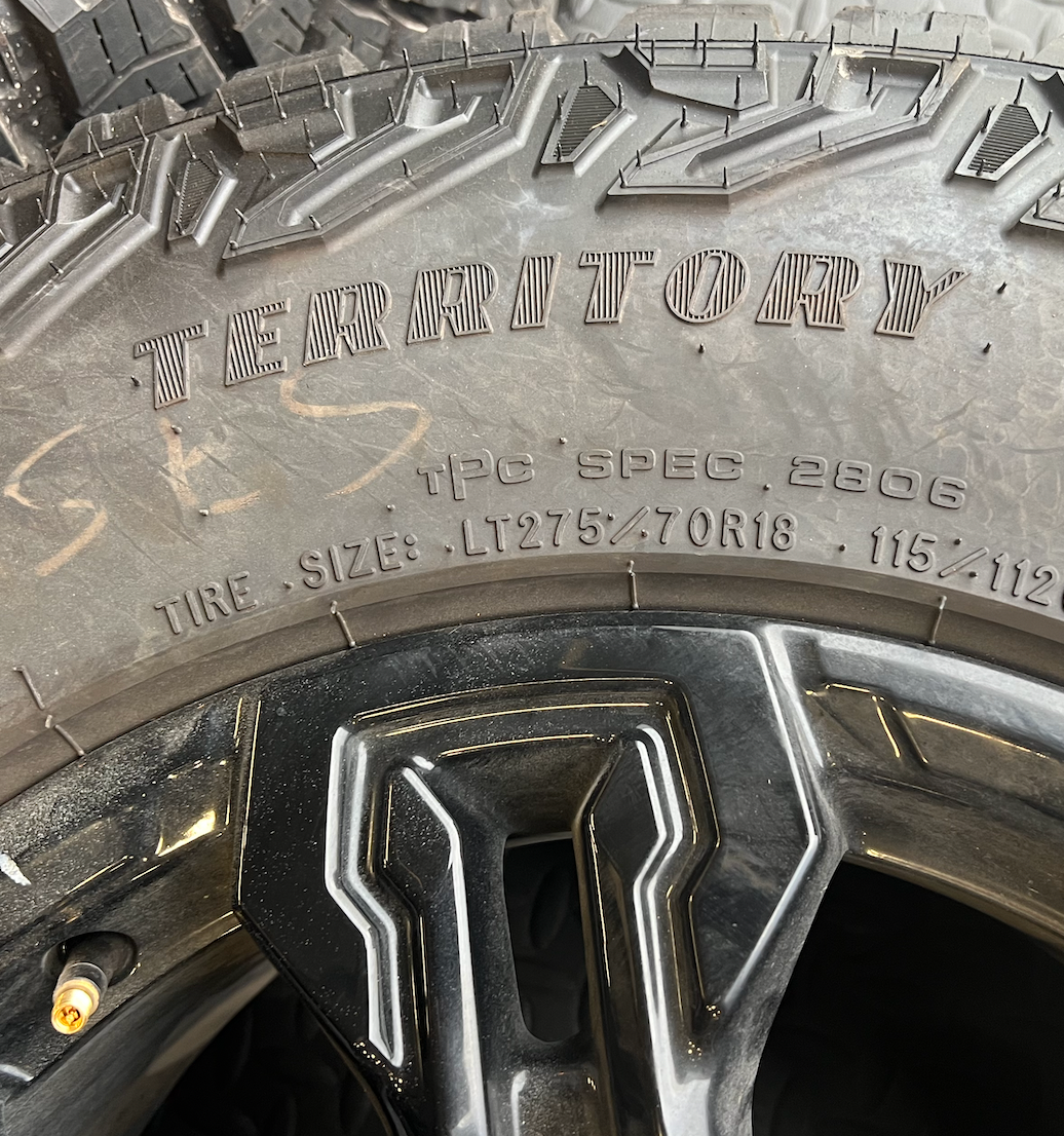 OEM 18” Gloss Black Chevrolet Silverado ZR2 Wheels wrapped in LT275/70R18 Goodyear Wrangler Territory MT tires.