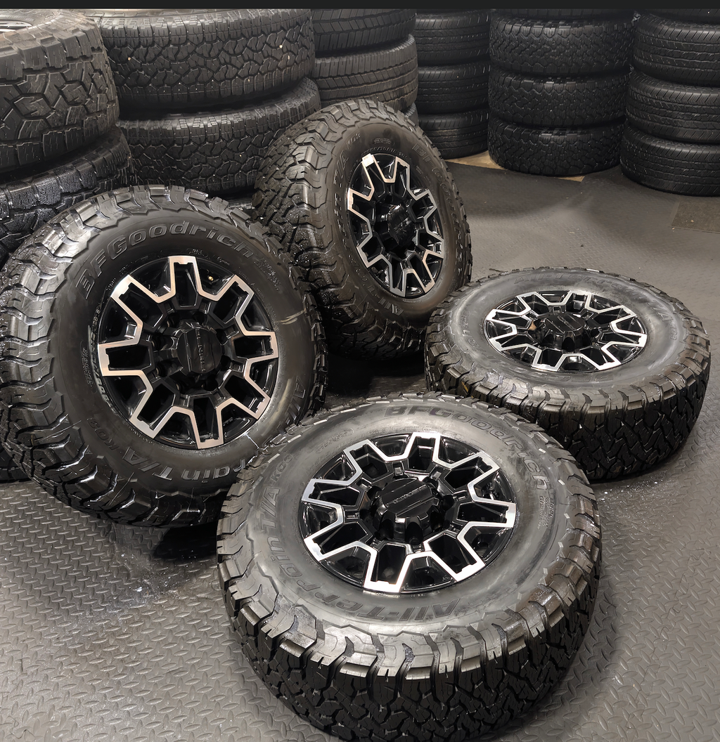 OEM 18” GMC Sierra 2500HD Wheels with Machined Black Finish wrapped in LT305/70R18 BFGoodrich All-Terrain T/A KO3 tires.