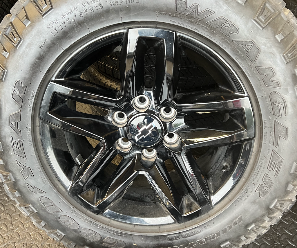 OEM 18” Gloss Black Trail Boss Wheels wrapped in Goodyear Wrangler Duratrac tires.