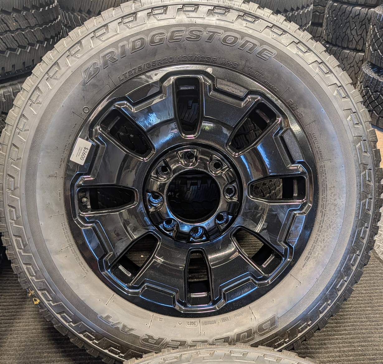 OEM 18” Ford F-250 / F-350 Tremor Wheels with Gloss Black Finish wrapped in Bridgestone Dueler A/T tires.