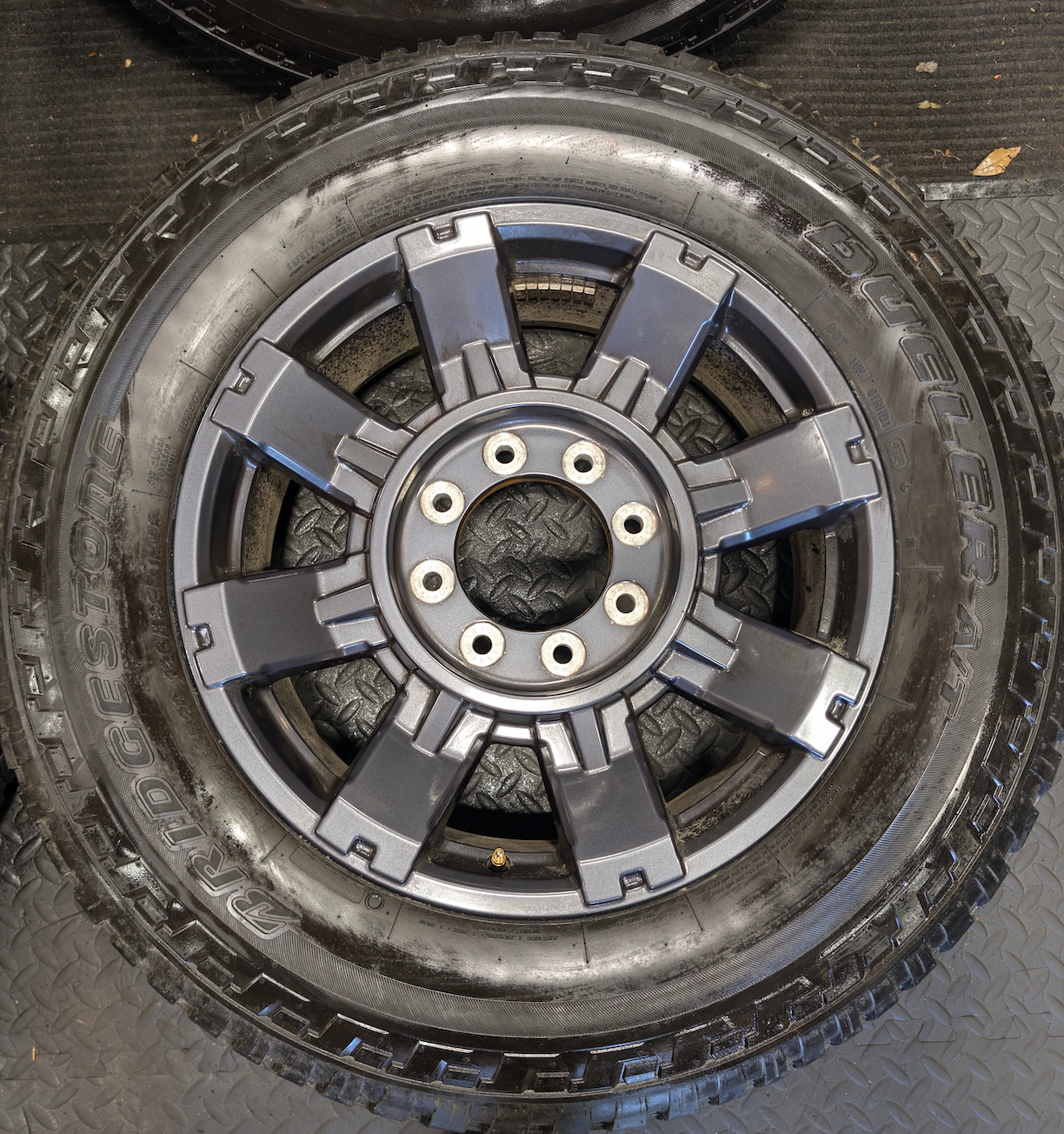 OEM 20” Dark Carbonized Gray Ford F-250 / F-350 Super Duty Wheels wrapped in Bridgestone Dueler tires.