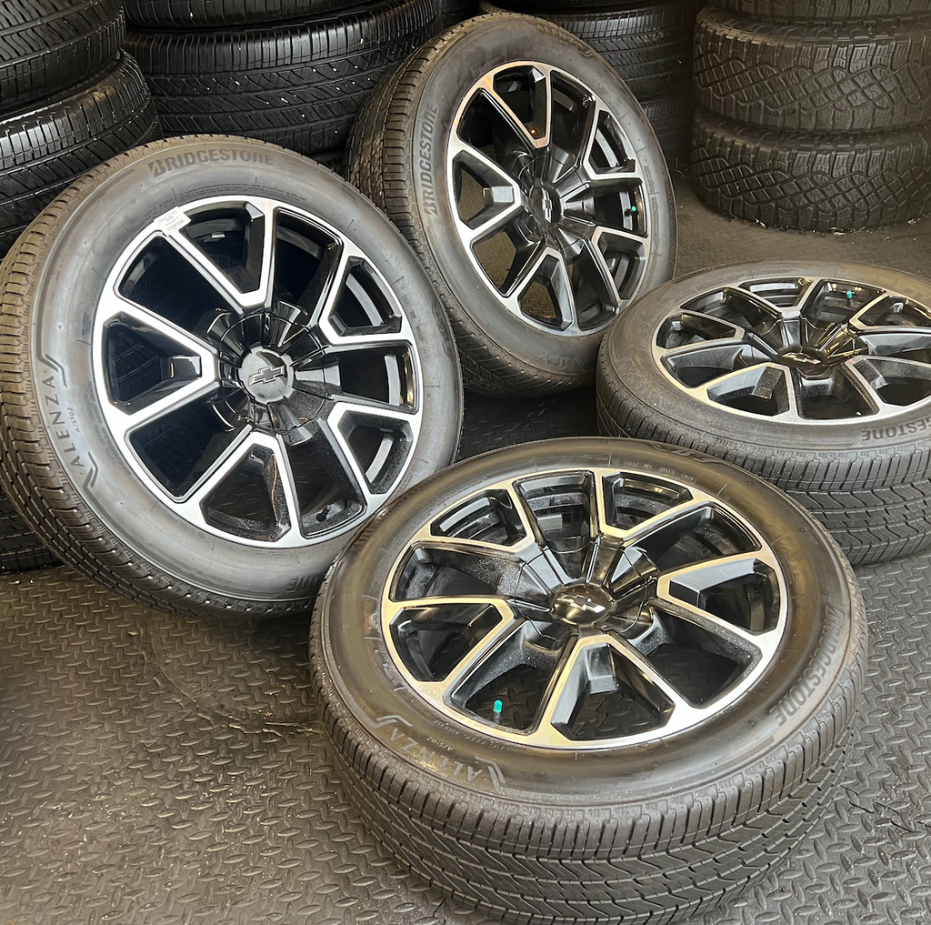 OEM 22” Black Machined Chevrolet Tahoe/Suburban Wheels wrapped in Bridgestone tires.