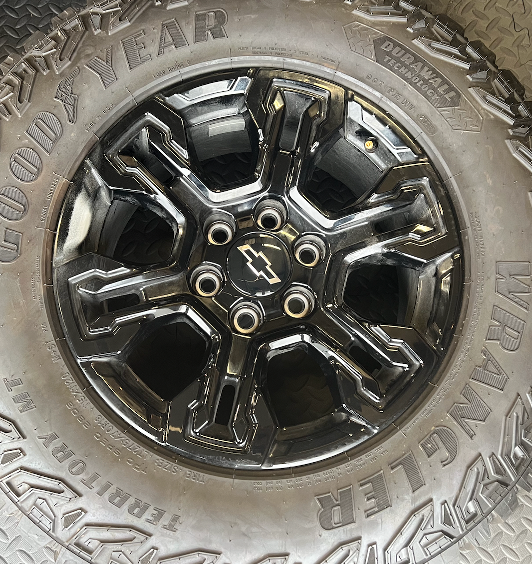 OEM 18” Gloss Black Chevrolet Silverado ZR2 Wheels wrapped in LT275/70R18 Goodyear Wrangler Territory MT tires.