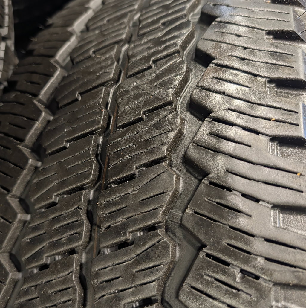 OEM 18” Ford F-250 / F-350 Tremor Wheels with Gloss Black Finish wrapped in Bridgestone Dueler A/T tires.