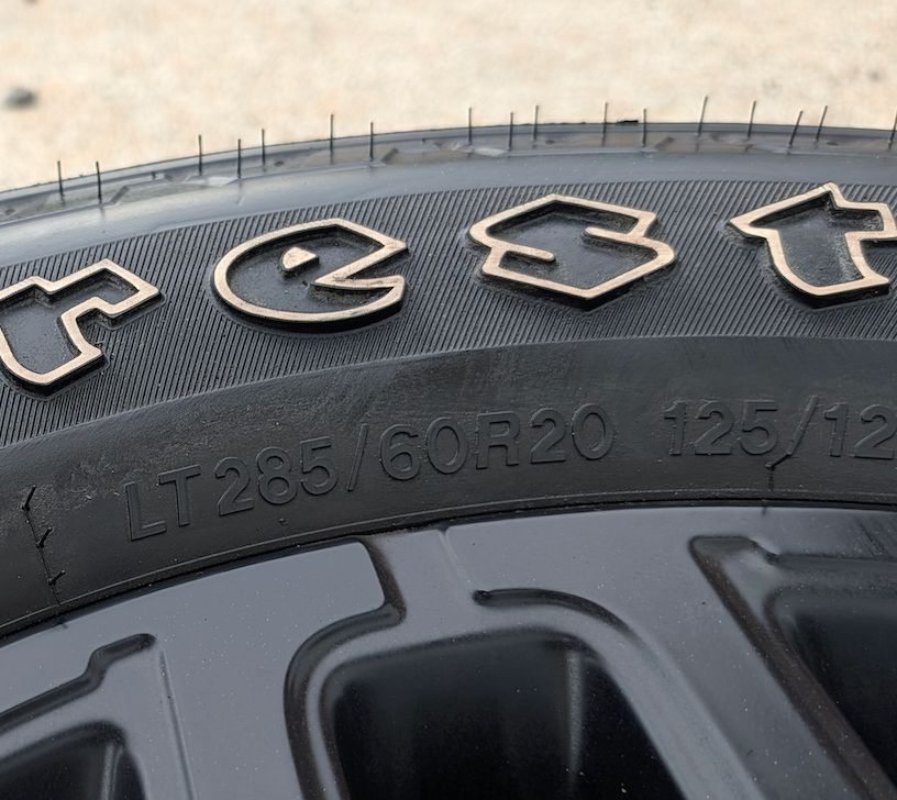 Matte Black Ram 2500 / 3500 OEM 20” Wrapped in Firestone Transforce AT2 LT285/60R20