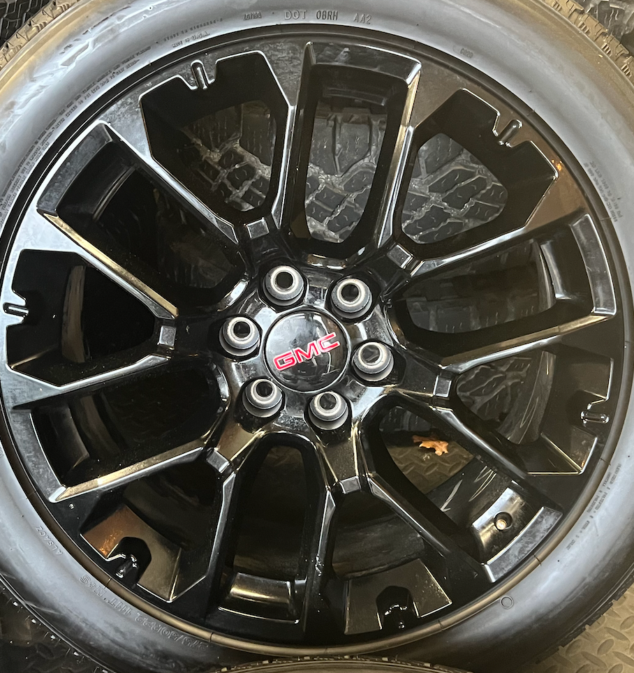 OEM 22” Gloss Black Replica Wheels wrapped in Bridgestone tires.