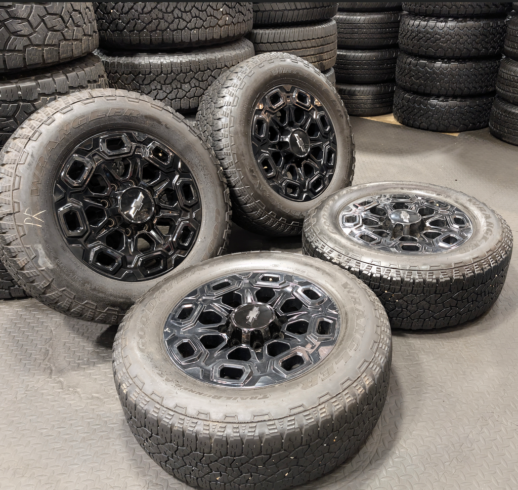 OEM 20” Gloss Black Chevrolet Silverado / GMC Sierra 2500HD & 3500HD Wheels wrapped in LT275/65R20 Goodyear Wrangler TrailRunner A/T tires.