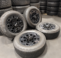 OEM 20” Gloss Black Chevrolet Silverado / GMC Sierra 2500HD & 3500HD Wheels wrapped in LT275/65R20 Goodyear Wrangler TrailRunner A/T tires.