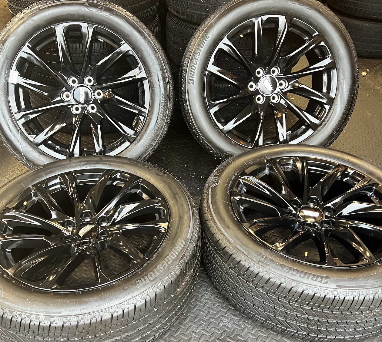 OEM 22” Gloss Black Wheels wrapped in Bridgestone tires.