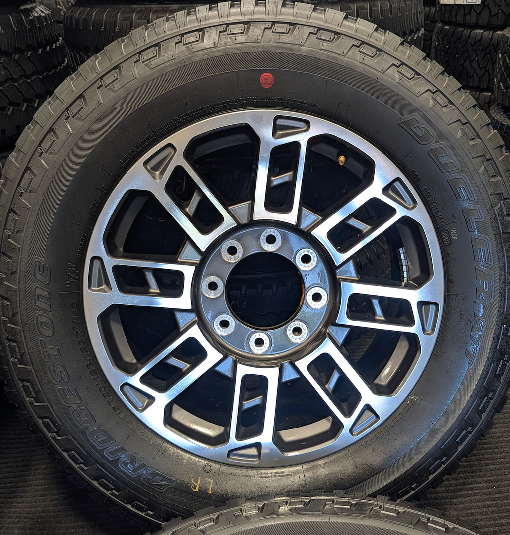 OEM 20” Ford Limited / Platinum Wheels wrapped in Bridgestone Dueler tires.