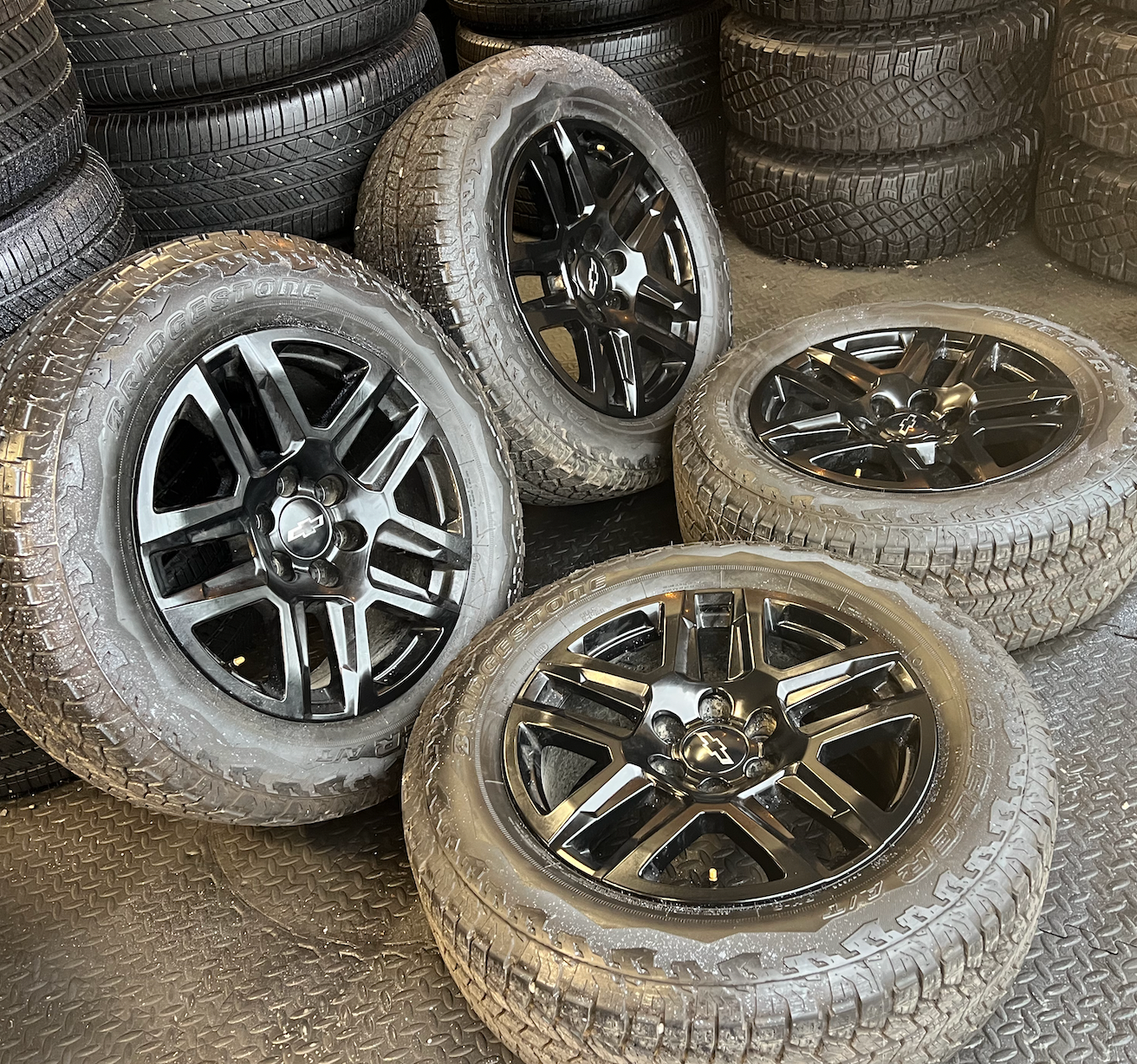 OEM 20” Gloss Black Wheels wrapped in Bridgestone Dueler A/T tires.