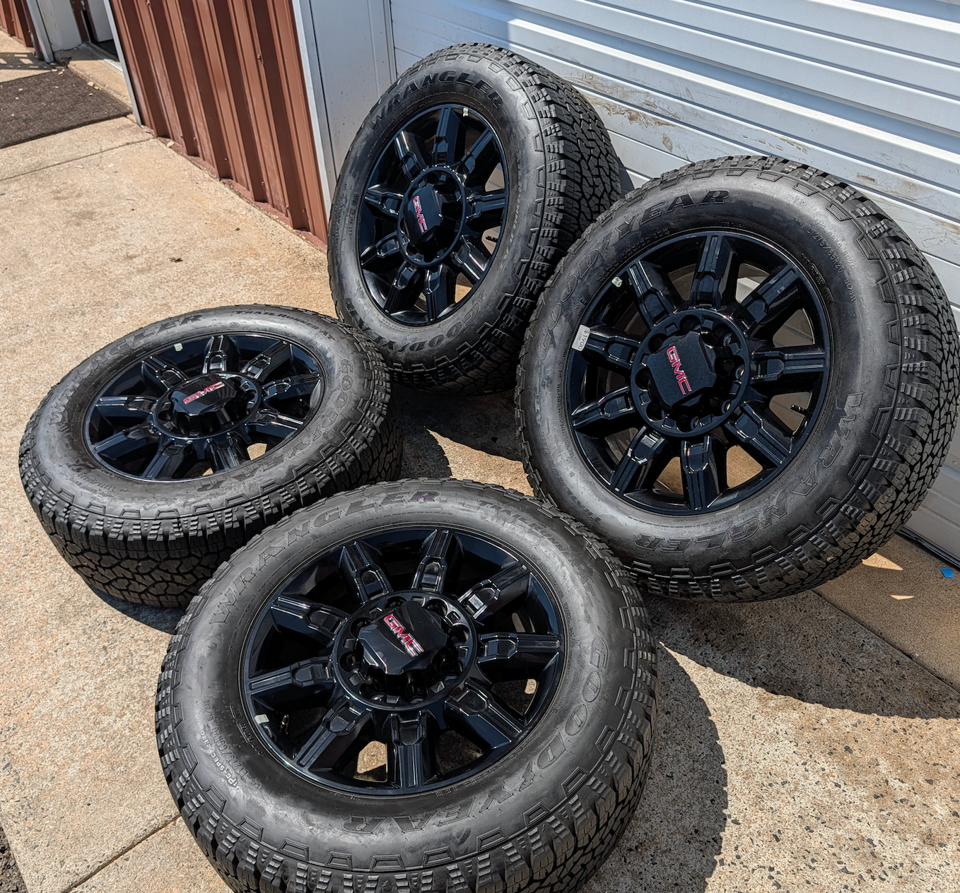 OEM 20” GMC Sierra 2500HD / 3500HD AT4 Black Wheels wrapped in Goodyear Wrangler TrailRunner A/T tires.