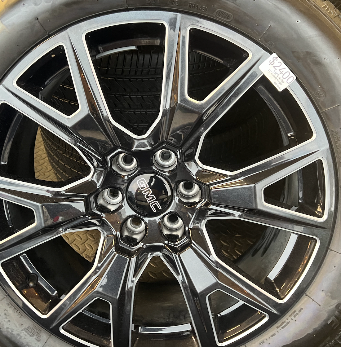 OEM 22” Gloss Black Machined Wheels wrapped in Bridgestone tires.