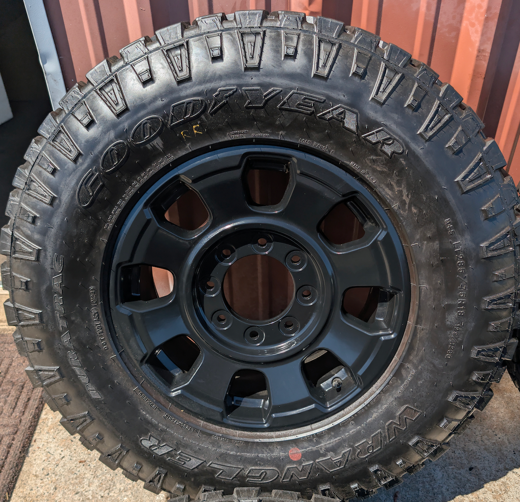 OEM 18” Ford F-250 / F-350 Tremor Wheels with Matte Black Finish wrapped in Goodyear Wrangler Duratrac tires.