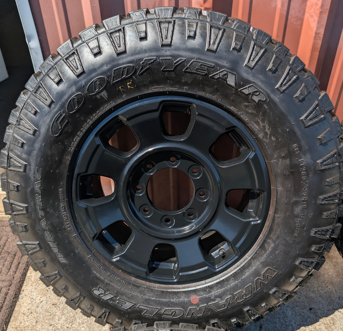 OEM 18” Ford F-250 / F-350 Tremor Wheels with Matte Black Finish wrapped in Goodyear Wrangler Duratrac tires.