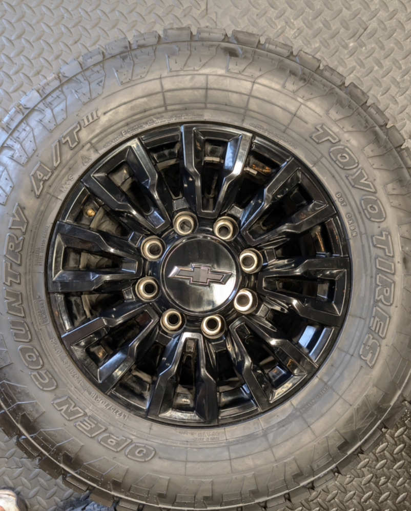 OEM 18” Chevrolet Silverado ZR2 2500HD / 3500HD Gloss Black Wheels wrapped in Toyo Open Country A/T tires.