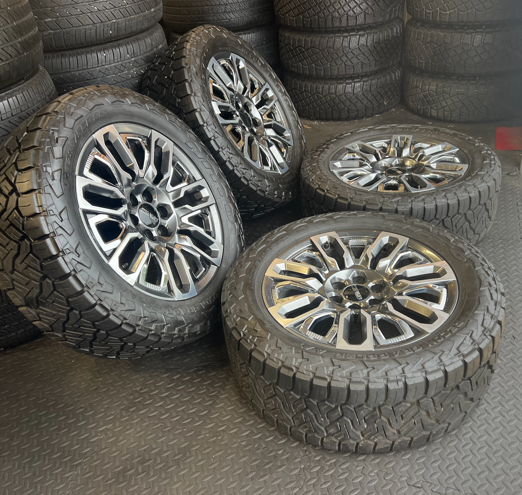 OEM 22”  Denali Ultimate Wheels with Charcoal Machined Finish & Chrome Inserts wrapped in Nitto Recon Grappler A/T tires.