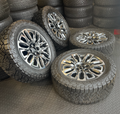 OEM 22”  Denali Ultimate Wheels with Charcoal Machined Finish & Chrome Inserts wrapped in Nitto Recon Grappler A/T tires.