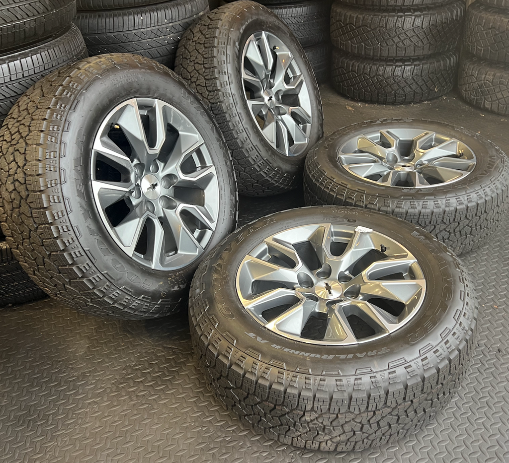 OEM 20”  Gunmetal & Machined Wheels wrapped in Goodyear Wrangler TrailRunner A/T tires.