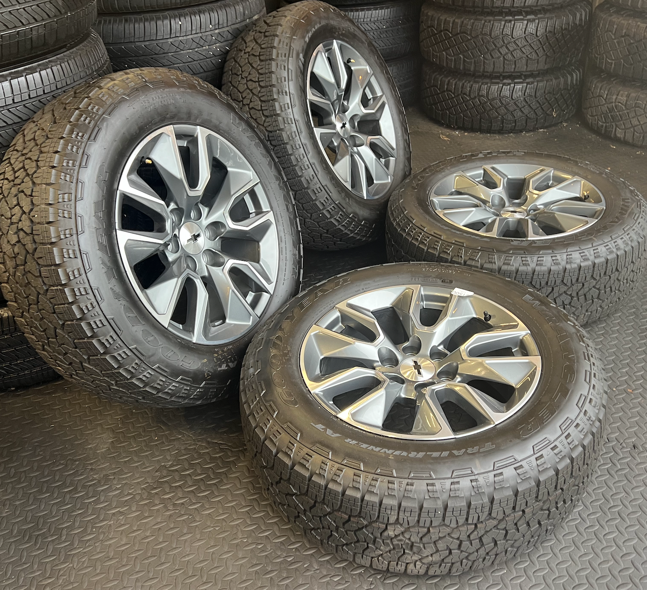 OEM 20”  Gunmetal & Machined Wheels wrapped in Goodyear Wrangler TrailRunner A/T tires.
