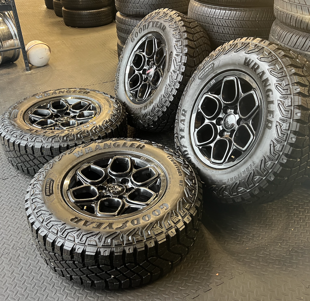 OEM 18”  Wheels wrapped in Goodyear Wrangler Territory M/T tires.