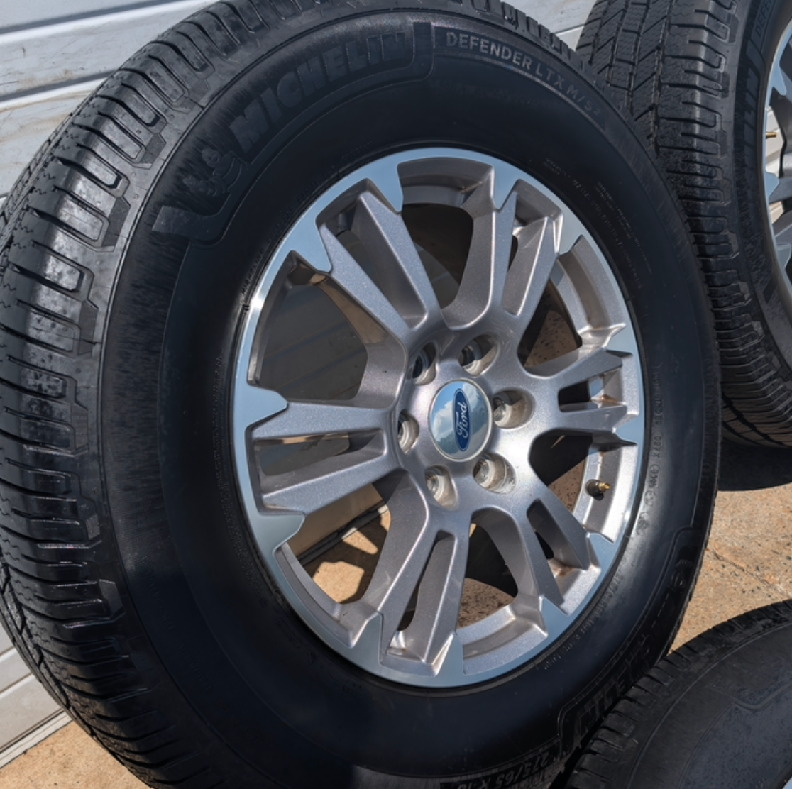 Gray Machined Ford F-150 Lariat OEM 18” Wrapped in Michelin Defender LTX 275/65R18