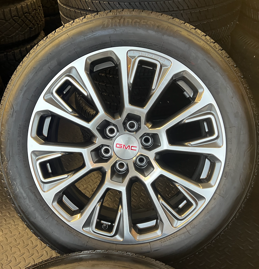 OEM 22” Machined Silver Denali Wheels wrapped in Bridgestone tires.